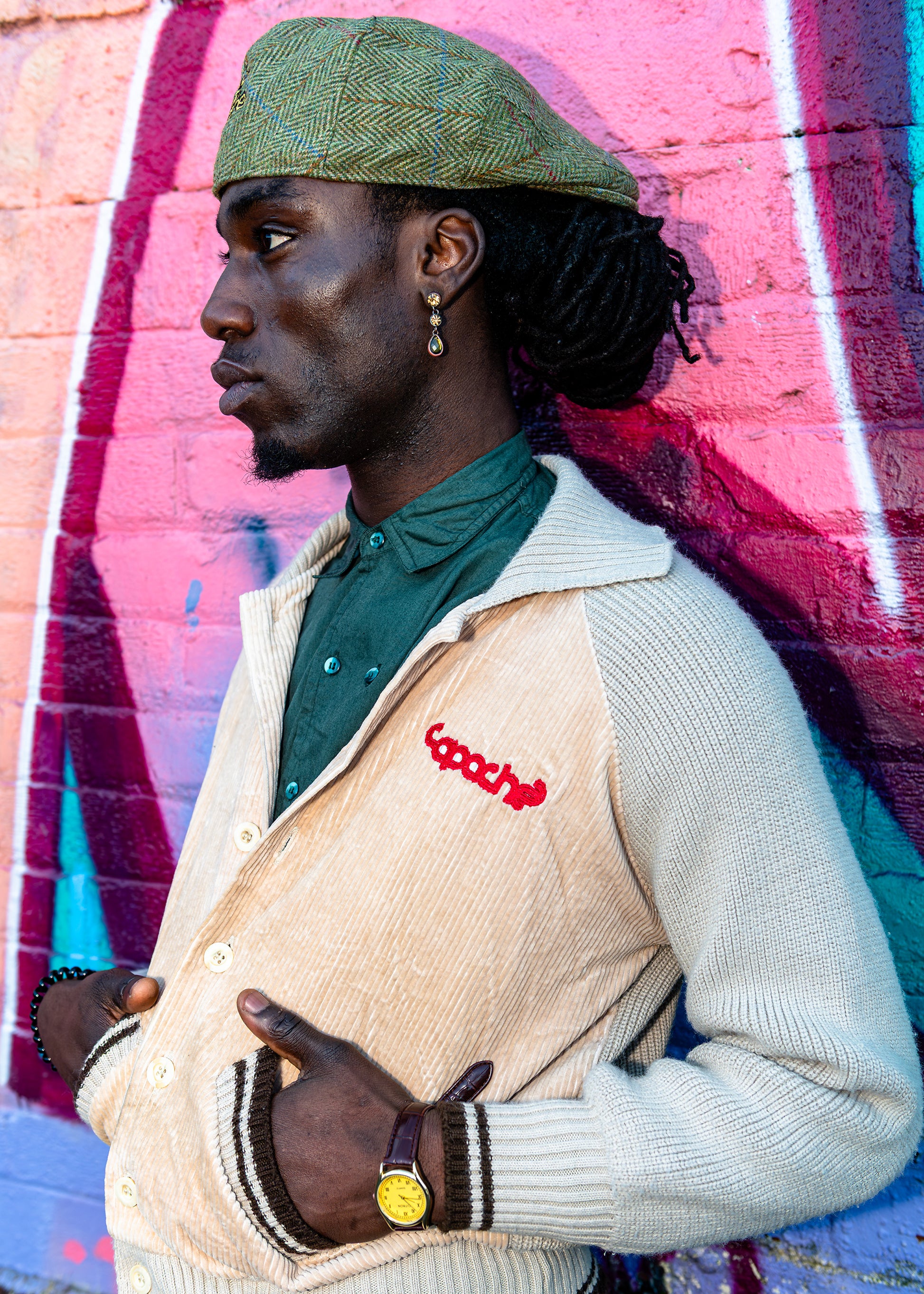 Apache Men's Cardigan in cream and beige corduroy with knit sleeves, brown striped trim, and red Apache logo embroidery
