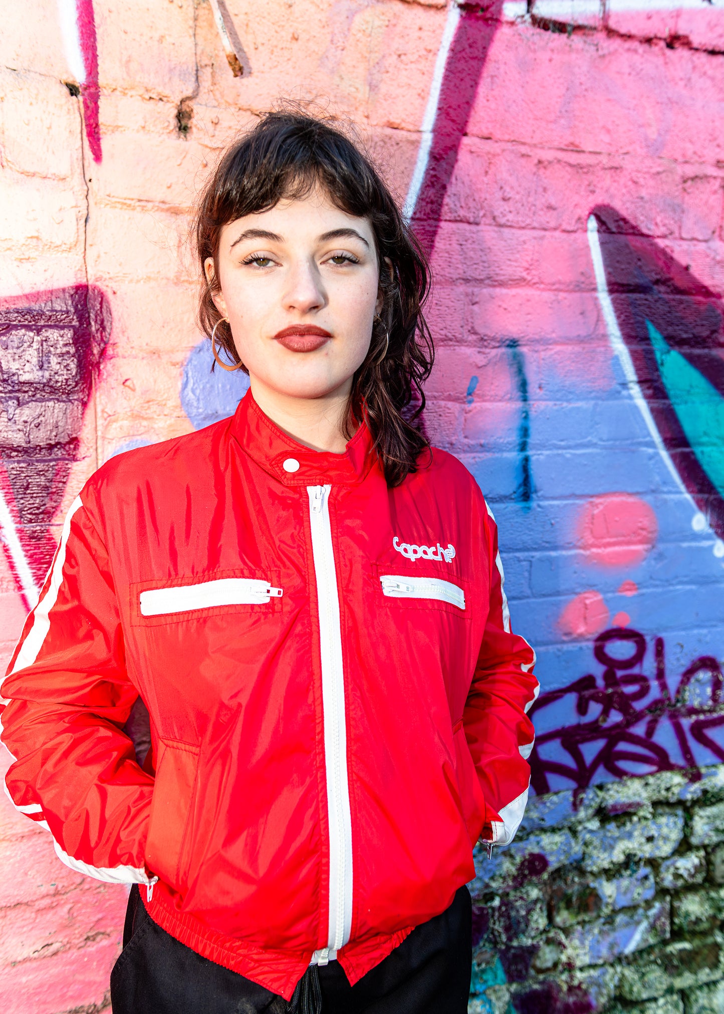 Red Track Jacket White Detail by Apache Tribe Belfast featuring bright red nylon with white zipper and stripe accents