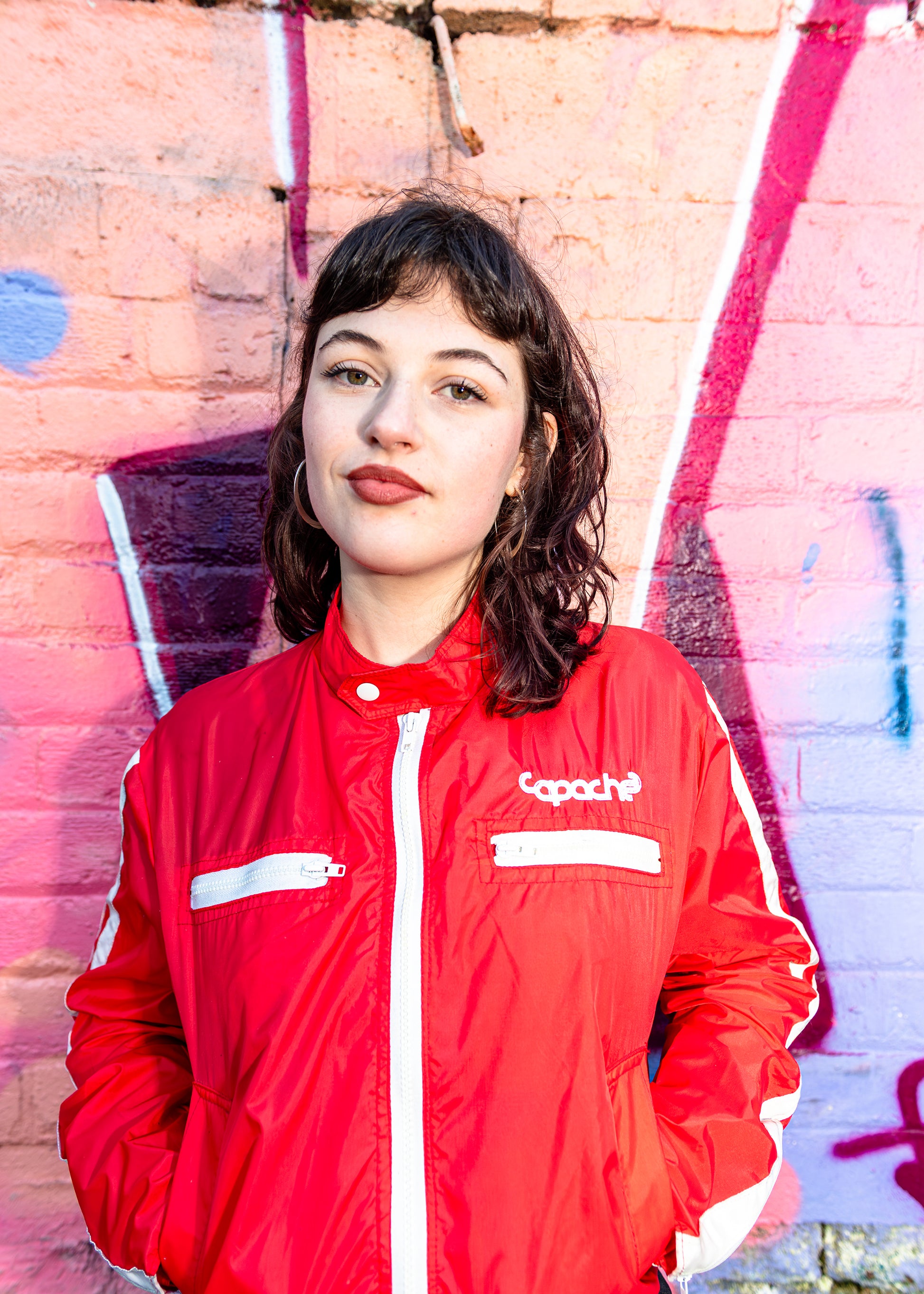 Red Track Jacket – White Detail by Apache Tribe Belfast, vibrant red nylon zip-up jacket with white piping and chest logo